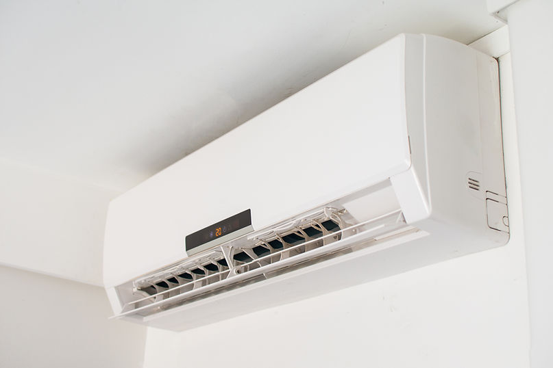 Wall-mounted white air conditioner unit with visible vents, displaying a temperature of 20°C