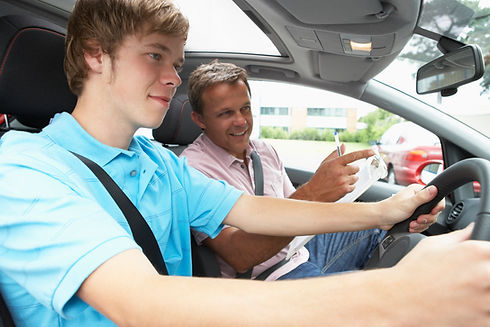 A boy having a driving test with an instructor