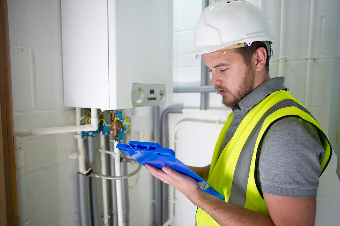 A professional inspecting a gas boiler using a clipboard