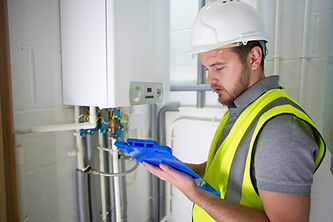 A professional examines a boiler