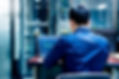 Male employee looking up data in a laptop PC