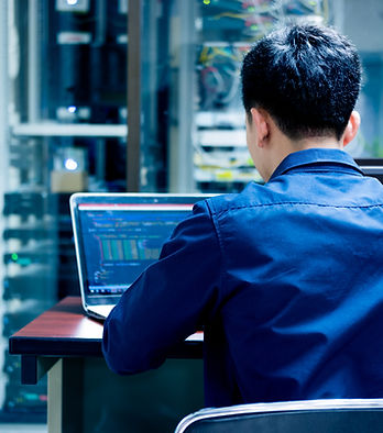 Male employee looking up data in a laptop PC