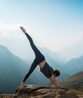 Woman doing yoga with mountain view