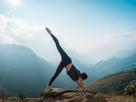 woman doing yoga with a mountain view