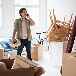 Mixed race man unpacking in new home