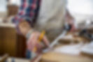 An antique furniture restorer measuring a piece of wood
