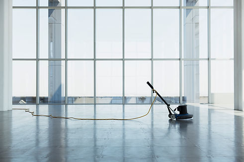 a highly skilled cleaning operative using a rotary floor polishing machine, the beautiful stone floor is of highly polished condition