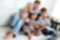 Portrait of happy family with two children sitting on sofa