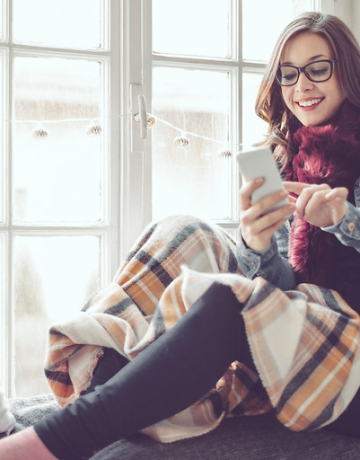 Young woman sitting by a window