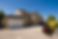 New build home in the picturesque Cotswolds, gravel drive and clear blue sky on a perfect