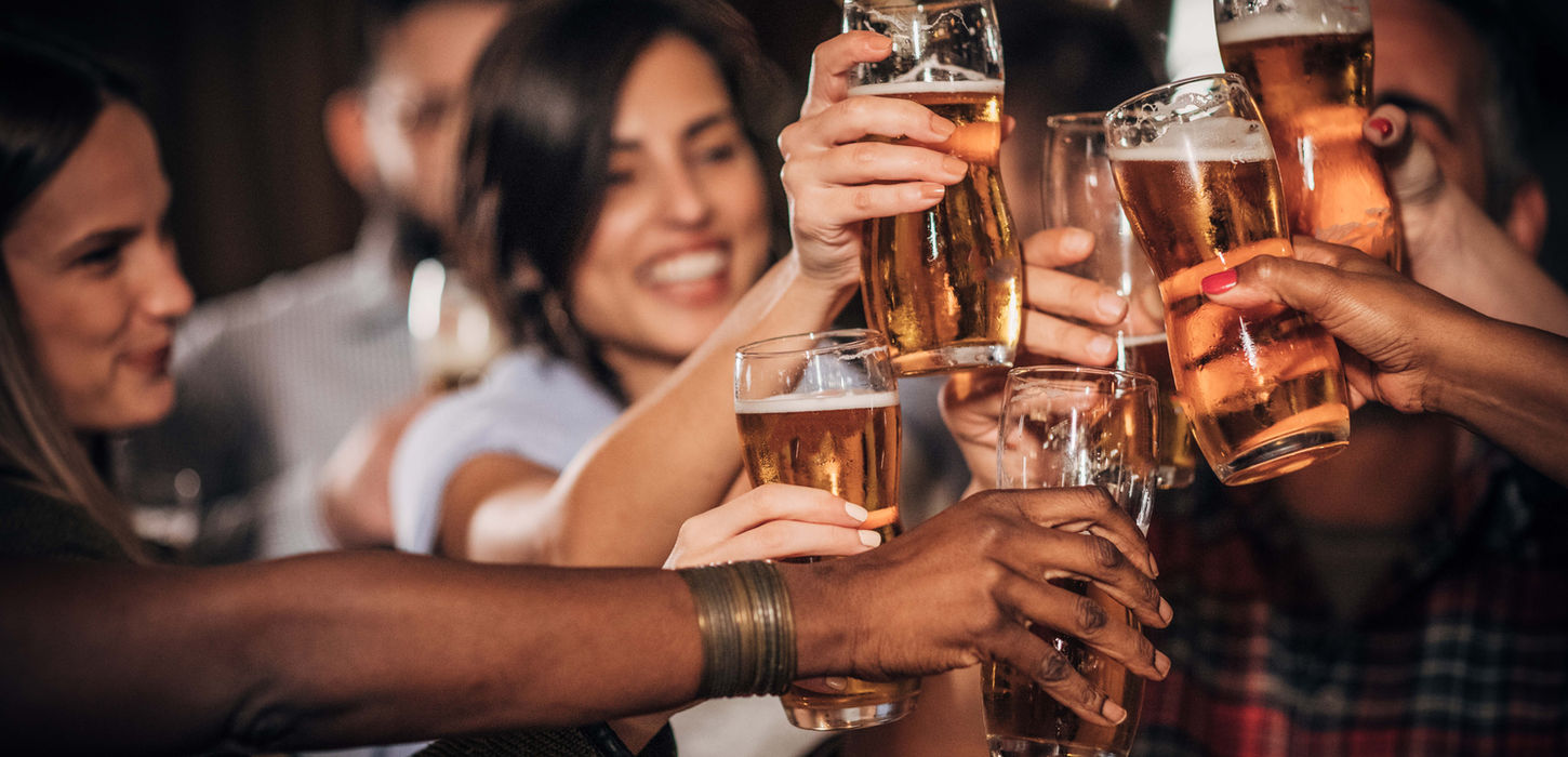 Group of friends toasting with beer glasses