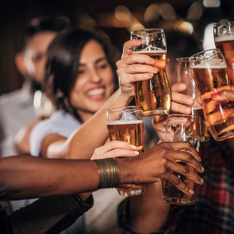 Diverse group of people toasting with beer