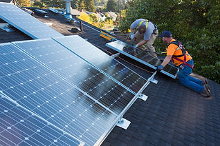 men installing panels on roof.