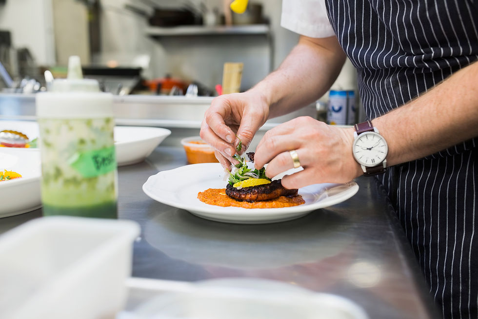 Chef plating food in commercial kitchen