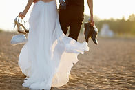 Couple Walking Barefoot on the Beach