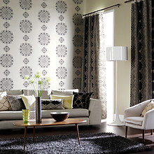 Contemporary living room with sofa and ornaments in front of large window with c