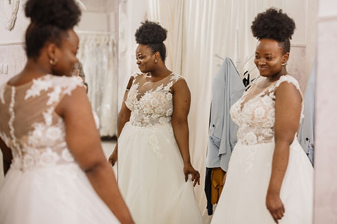 The future bride looks around the shop and tries on wedding dresses