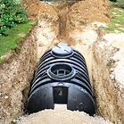 Black septic tank being installed