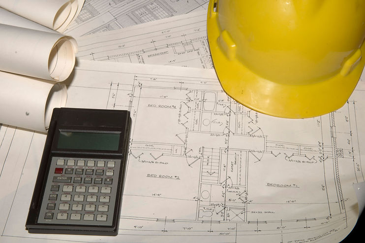 Blue Prints with hard hat and calculator