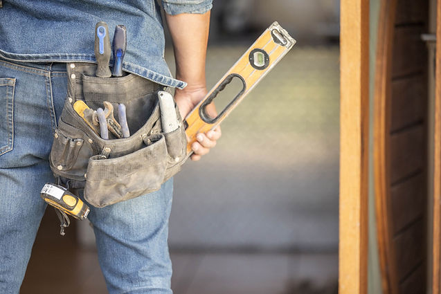 Handyman with tool belt and level