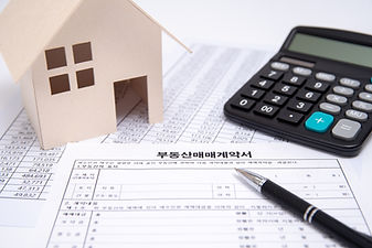Real Estate Contract with Pen and Calculator