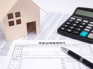 Real Estate Contract with Pen and Calculator