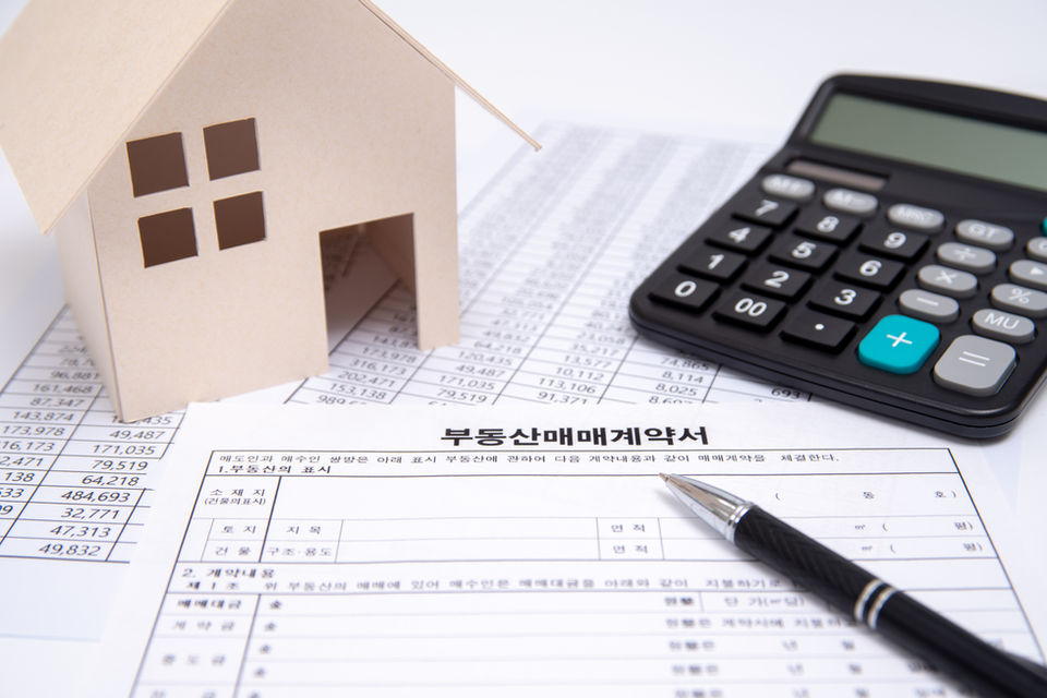 Real Estate Contract with Pen and Calculator