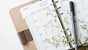 Calendar with greenery and pen