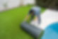 Worker installing artificial grass surface