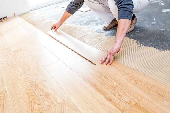 Man installing floors in new house