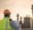 Engineer Looking At Blueprint On Site