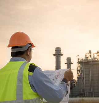Engineer Looking At Blueprint On Site