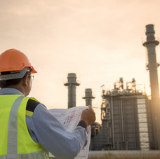Engineer Looking At Blueprint On Site