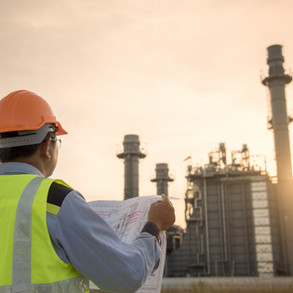 engineer-looking-at-blueprint-on-site