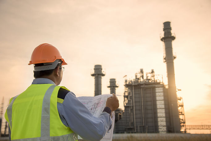 Engineer Looking At Blueprint On Site
