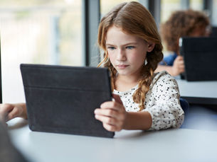 Child learns on a tablet