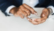 Hands typing on smart phone