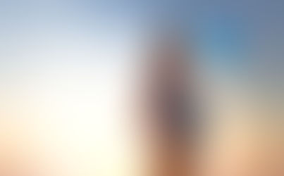 Adult hand gently holds a baby's hand on a soft, white blanket, conveying warmth and tenderness.