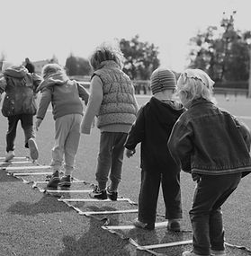 Black and white photograph of children playing outside 