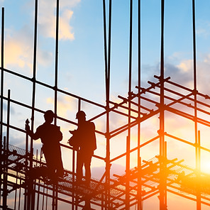 construction worker on construction site at sunset