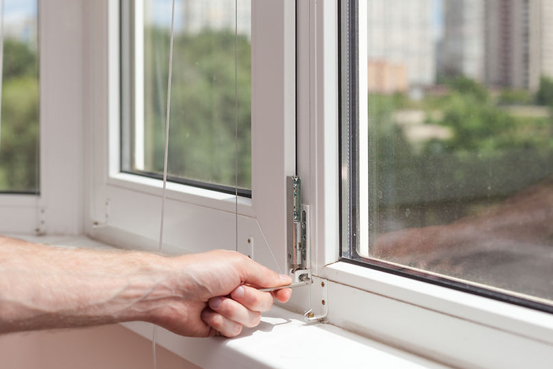 close-up image of a person's hand while repairing windows