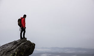 Individual reflecting by the ocean, representing inner peace and self-discovery.