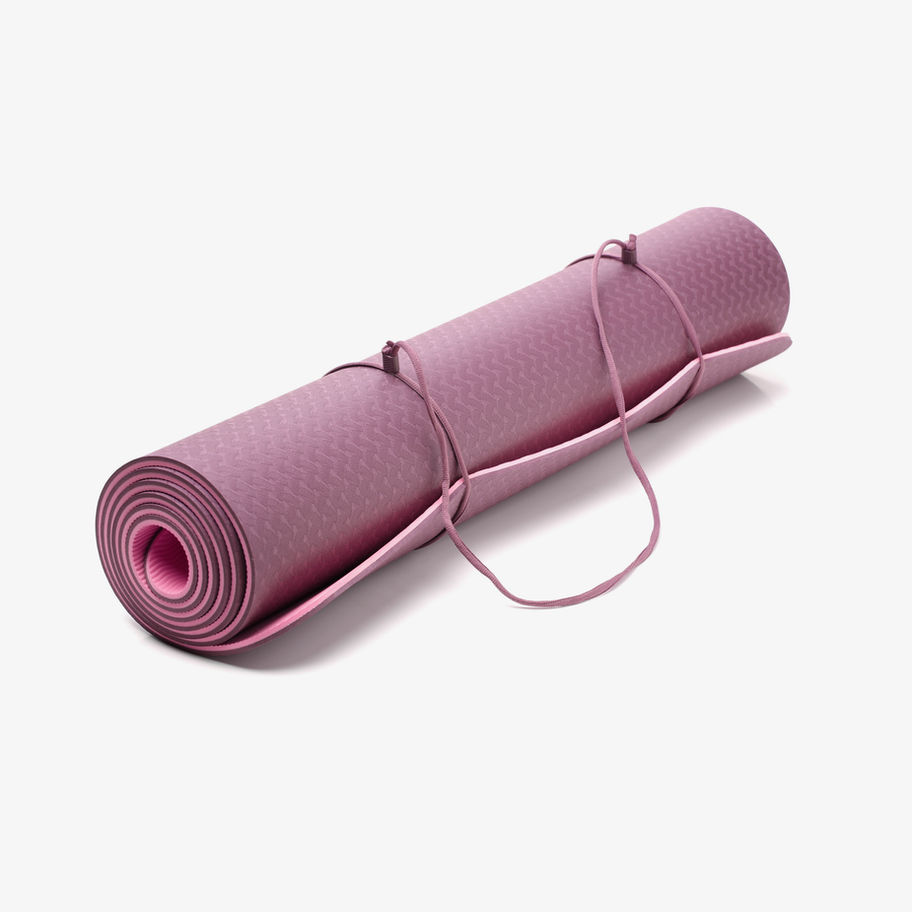 Rolled purple yoga mat with carrying straps