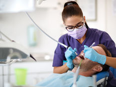 A dental surgery graduate working on a patient. 