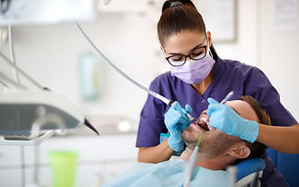 Dental hygienist cleaning teeth
