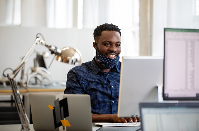 Canadian man Working on laptop with Face Mask