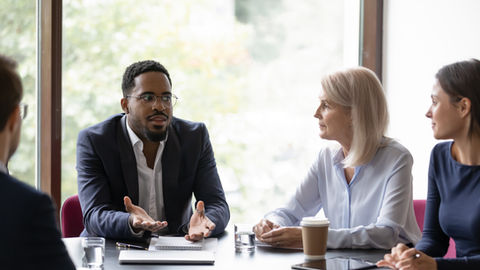 Businessman speaking to colleagues in a meeting