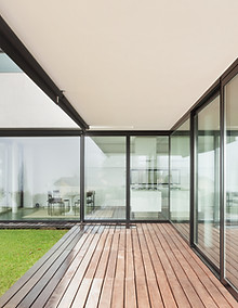 Looking into a modern property with bifold doors that offer breathtaking views and easy access to the outdoor space finished with composite decking