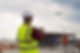 A construction worker using a drone at a construction site