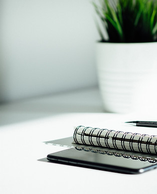 Pen, notebook, and smartphone on the table